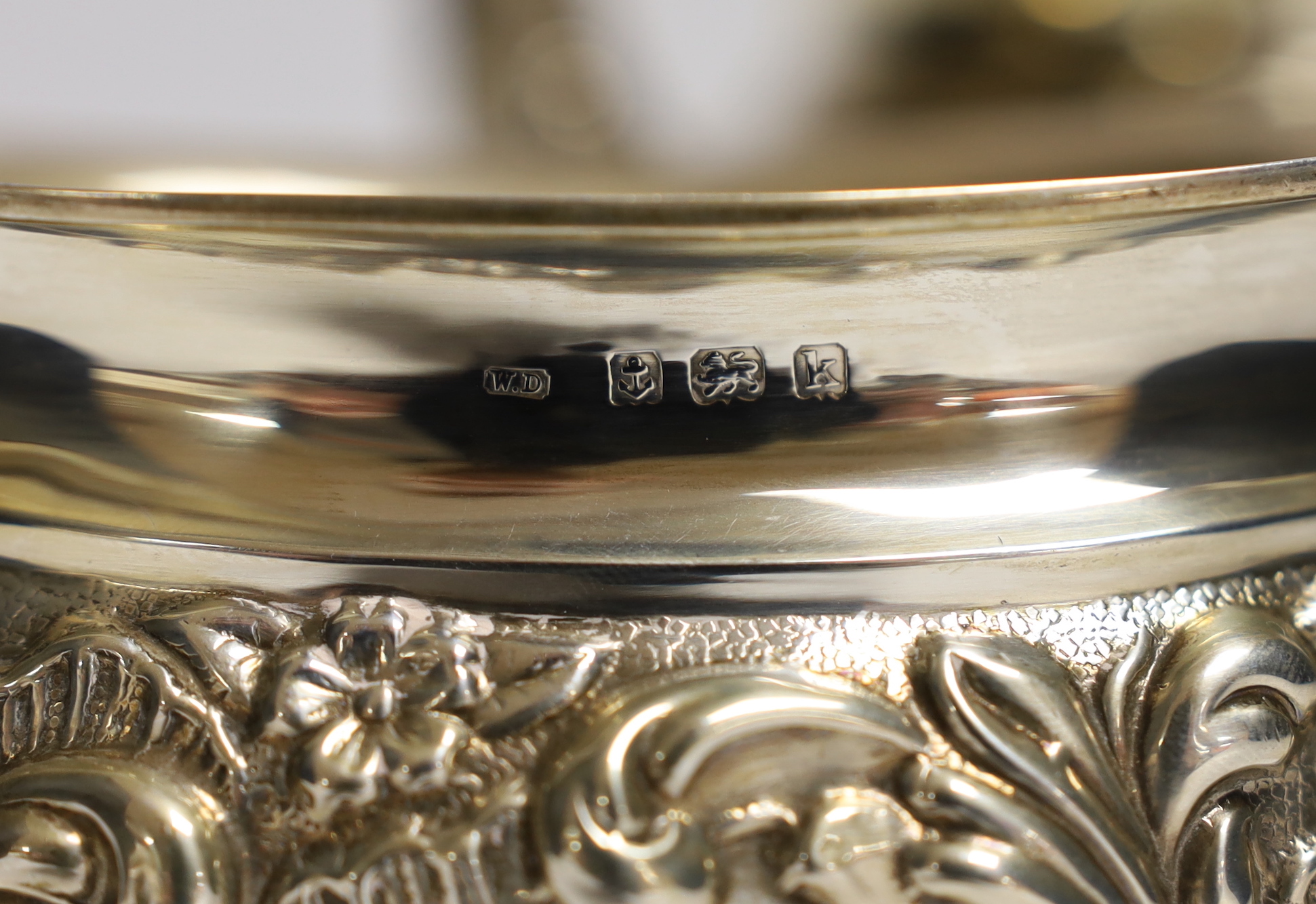 An Edwardian embossed silver three piece tea set, William Devonport, Birmingham, 1909